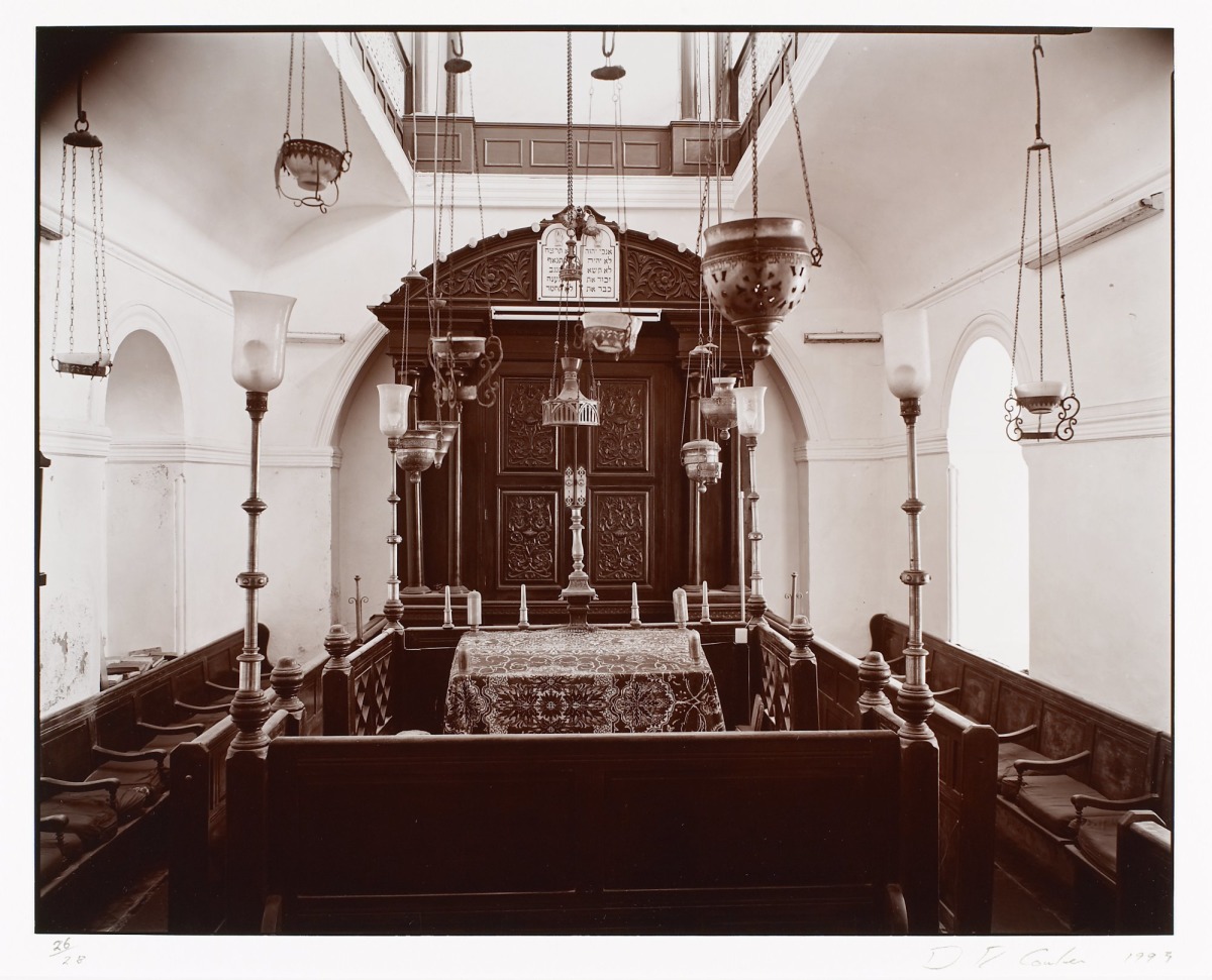 Interior view of the restored Slat Lkahal synagogue in Essaouira showing ornate woodwork and Hebrew inscriptions